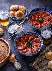 Prawns with tomato sauce, beer and buns, dark photo