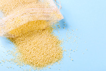 Couscous dry on a blue colored Background. Copy space for Text. Flat Lay.