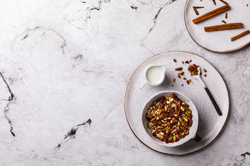 Fototapeta na wymiar Granola cinnamon with milk on a marble Background. Breakfast Healthy Food. Diet Nutrition Concept. Top View. Flat Lay.Copy space for Text.