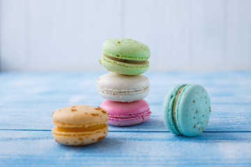 Multicolored macaroons on blue background.