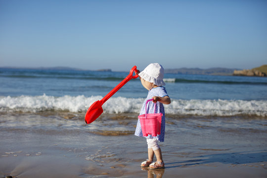 baby girl playing at summer beach