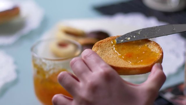 genuineness, health, breakfast. Putting the jam on the biscuit slice