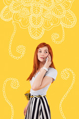 Phone conversation. Pretty young model wearing beautiful clothes and turning her head while talking on the phone