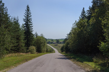 Fototapeta na wymiar Country landscape, asphalt road through the hills