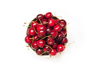 Obraz na płótnie Canvas Fresh sweet cherry in a bowl isolated on a white background, top view. Prunus avium. Close-up wild cherry fruit