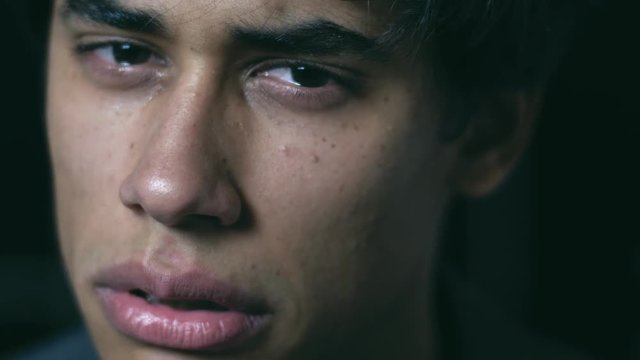 anxiety, despair, depression.Young man crying in the darkness