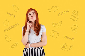 Fototapeta premium Good diet. Cheerful pretty actress looking into the distance and smiling happily while enjoying her new diet