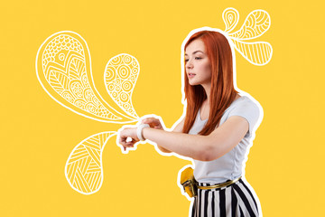 Fototapeta premium Convenient watch. Progressive parent feeling confident while using a modern smart watch for controlling the kids