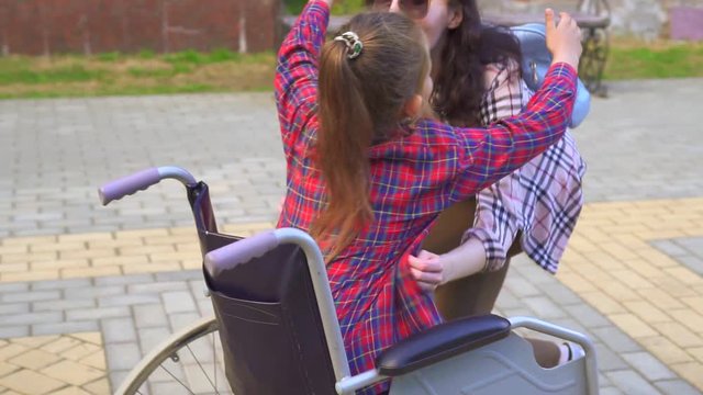 a disabled woman in a wheelchair mother hugs daughter steady shot