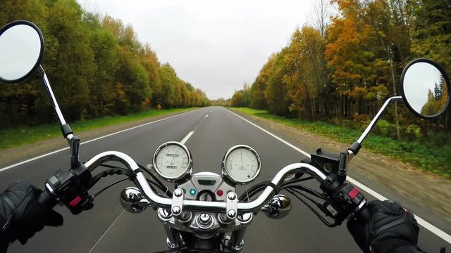 4K. Fast motorcycle riding on the beautiful forested road, wide point of view of rider. Classic cruiser/chopper forever! 
