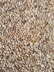 Ground stone background of many small stones.	