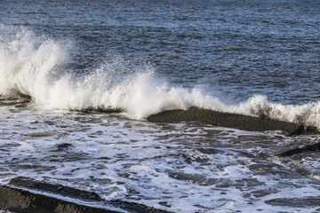 Waves breaking over rocks