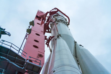 Spaceship with a satellite on the launch pad