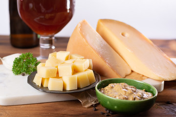 Famous Dutch finger food usually served with glass of beer, cubes hard old Dutch cow and goat cheese with Dijon mustard