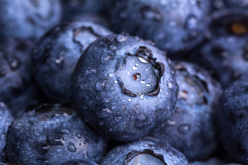 Fresh ripe blueberry with drops of dew. Berry background. Macro photo.