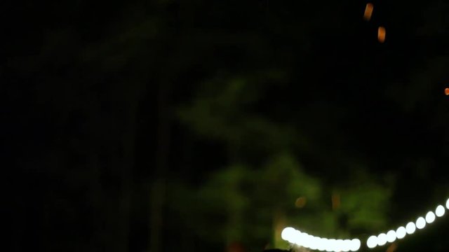 Women dancing around the fire at night
