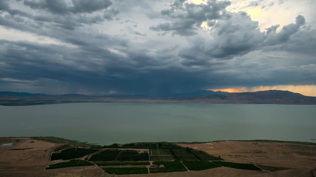 Time lapse of dark storm clouds building over Utah Lake in the evening.