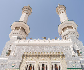 Fototapeta na wymiar MECCA, SAUDI ARABIA - MAY 02 2018: View on Al Masjid Al Haram mosque in Mecca. Two minarets are the main entrance. Holy Kaaba is inside this mosque