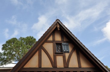 Exterior of attic of an old house in blue skies