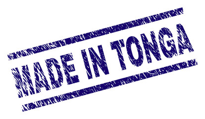 MADE IN TONGA stamp seal watermark with scratced style. Blue vector rubber print of MADE IN TONGA label with corroded texture. Text label is placed between parallel lines.