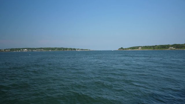 A wide shot view of Portland, Maine's Fore River harbor. Cushing Island and Fort Scammel in the distance. Shot at 48fps.  	