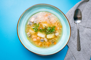 Fish soup on blue plate