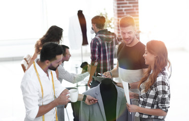 Obraz premium group of designers discuss men's suit