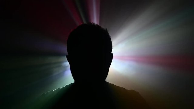 silhouette of a man looking around