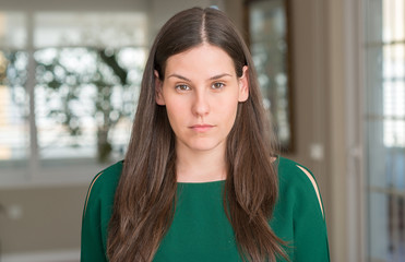 Young beautiful woman at home with a confident expression on smart face thinking serious