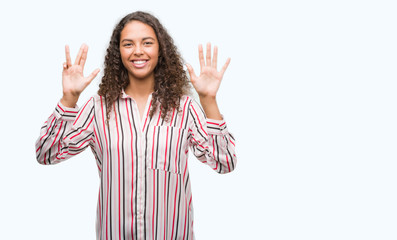 Beautiful young hispanic woman showing and pointing up with fingers number nine while smiling...