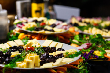 Food platters full of fresh vegetables, cheese cubes, sprouts and dates