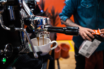 Fototapeta na wymiar Fancy stainless steel coffee machine pouring a double espresso in a coffee shop
