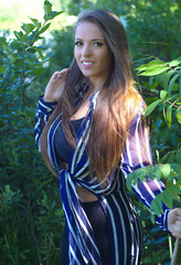 women smile young beauty in forest natural trees green vegetation sunlight