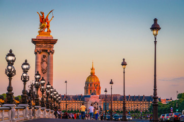 Beautiful sunset view on Pont Alexandre III and Les Invalides in Paris, France