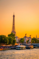 Sunset view of  Eiffel Tower, Alexander III Bridge and river Seine in Paris, France.