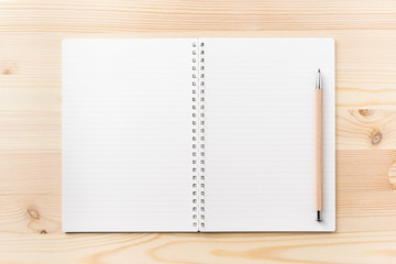 Design concept - Top view of black kraft spiral notebook and wood mechanical pencil on wood table background for mockup