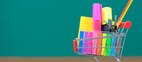 Back to school and Education concepts with shopping cart, pencil, highlighter and notepad