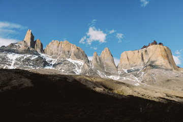 Torres del Paine. Snowy rocks of unusual shape against the sky. Dramatic landscape