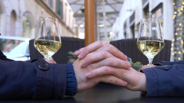 Woman hand and man hand touching,holding on the table-outdoor.Love,flirt.romance