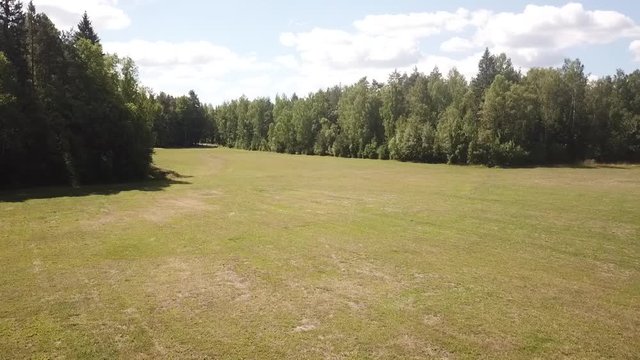 dron from left to rigth over a meadow in sweden slow