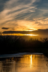Reflection of sunset on water on a winter day 
