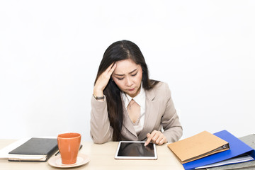 Portrait of beautiful 40-50 years.Businesswoman working with tablet and office Supplies.She looking strain.Copy space.