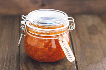 Glass jar with cloudberry jam. Nordic cuisine.