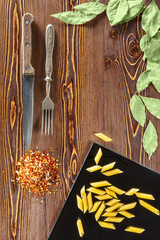 pasta and spices on wooden background