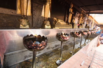 brass candlestick and Buddha statue on Thailand temple
