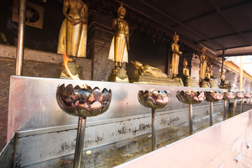 brass candlestick and Buddha statue on Thailand temple
