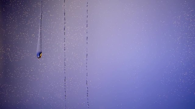 Drops and water rinse down glas of water on bluresceen
