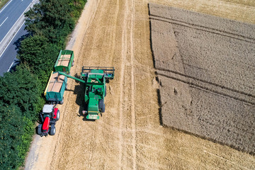 Aerial view on combine harvester working on the large wheat field in Germany