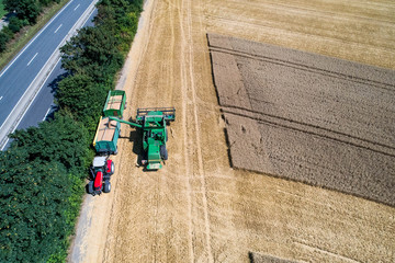 Aerial view on combine harvester working on the large wheat field in Germany