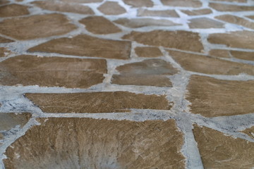 pavement path for pedestrians from trolley plates of irregular shape made of natural layered stone